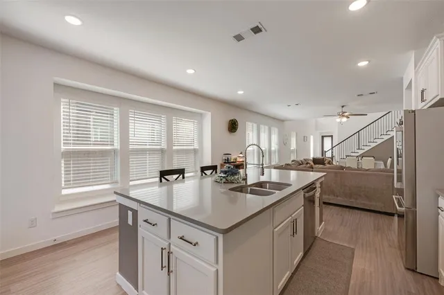 a kitchen with a sink stove and cabinets