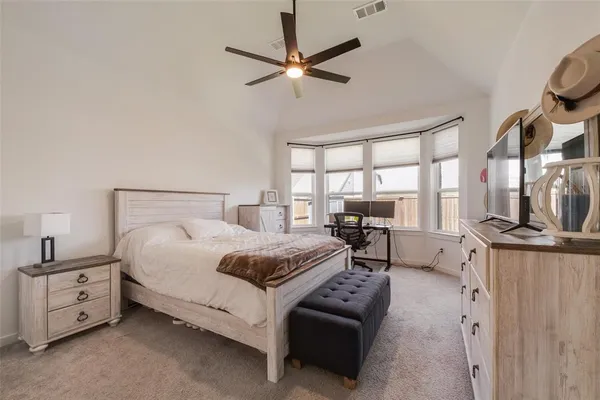 a bedroom with furniture and a large window