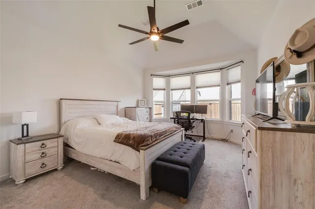 a bedroom with furniture and a large window