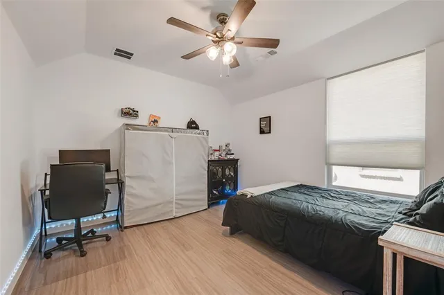 a bedroom with a bed and a chair