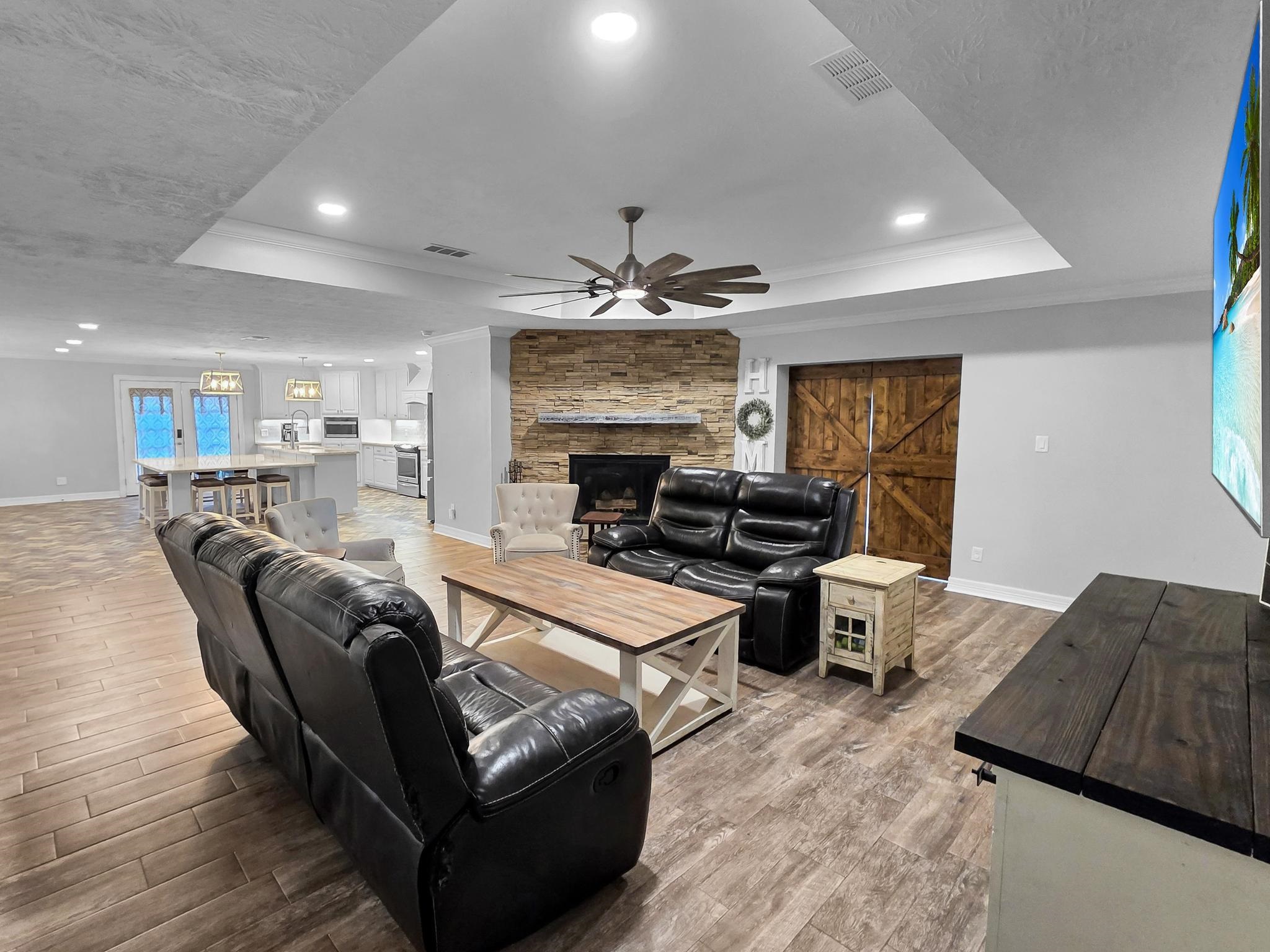 2641 Oilla Road Orange, TX 77630 - Photo 11 of 50 a living room with furniture a fireplace and a chandelier
