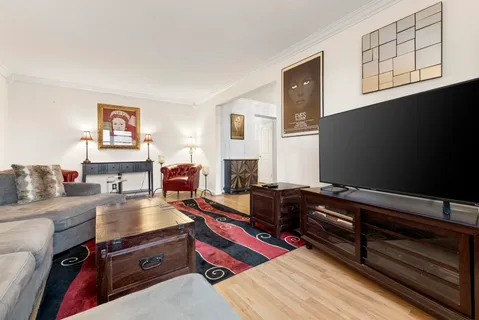 a living room with furniture fireplace and flat screen tv