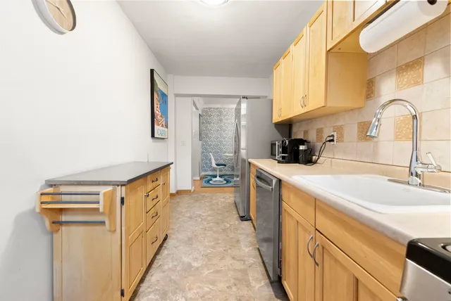 a kitchen with stainless steel appliances granite countertop a sink and a stove