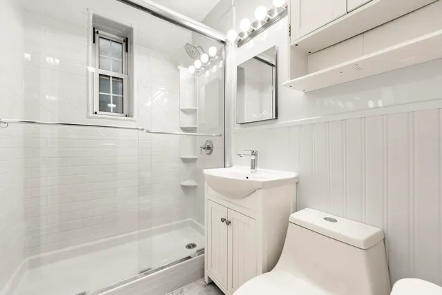 a bathroom with a sink toilet and shower
