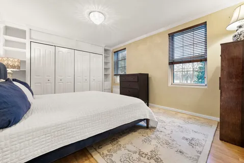 a bedroom with a bed and a dresser