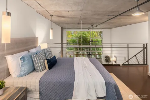 a bed sitting in a bedroom next to a window