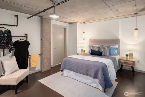 a bedroom with a bed and a chair