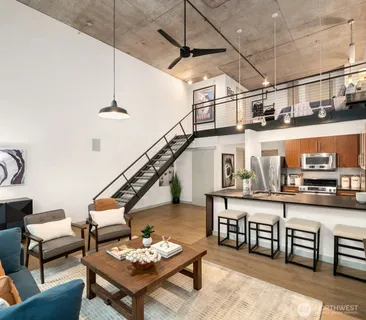 a living room with lots of furniture and a wooden floor