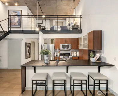 a kitchen with a table chairs stove and cabinets