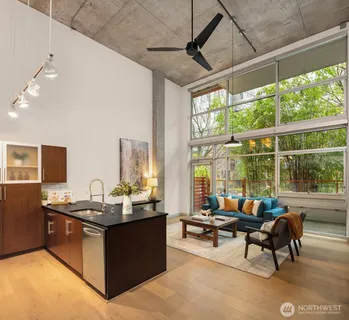 a living room with furniture and floor to ceiling windows