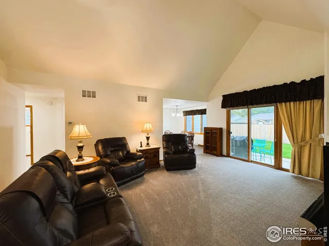 a living room with furniture and large windows