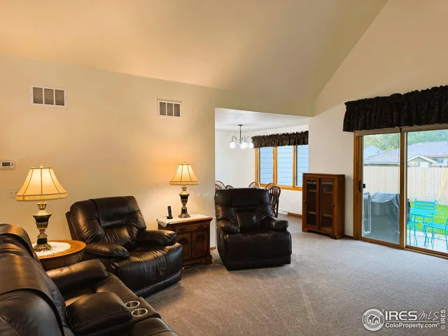 a living room with furniture and a floor to ceiling window