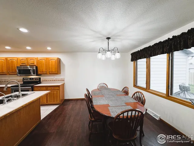 a view of a a dining room with furniture window and wooden floor