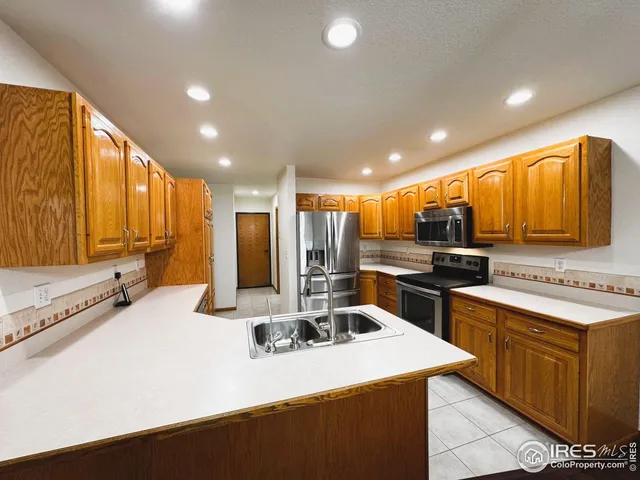 a kitchen with a sink a stove and cabinets