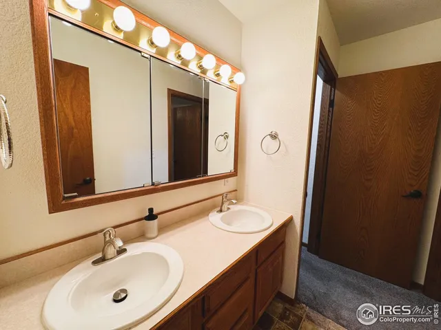 a bathroom with a double vanity sink and a mirror