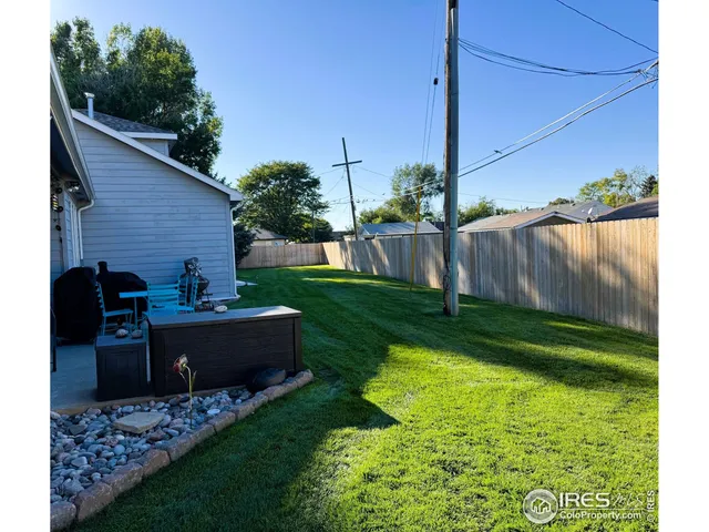 a view of backyard with seating area and green space
