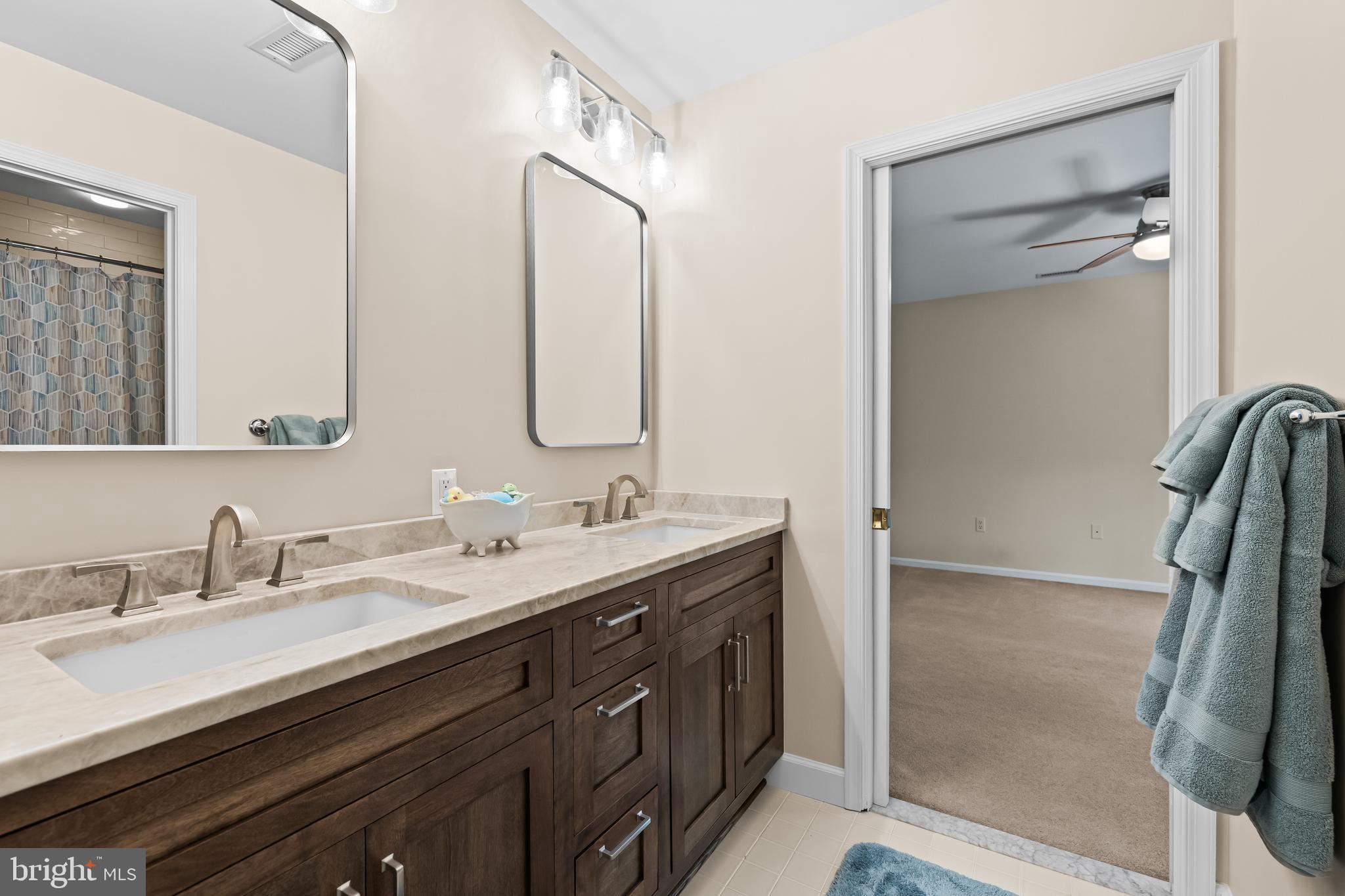 2428 Old Bosley Road Cockeysville, MD 21030 - Photo 38 of 53 a bathroom with a double vanity sink a and mirror