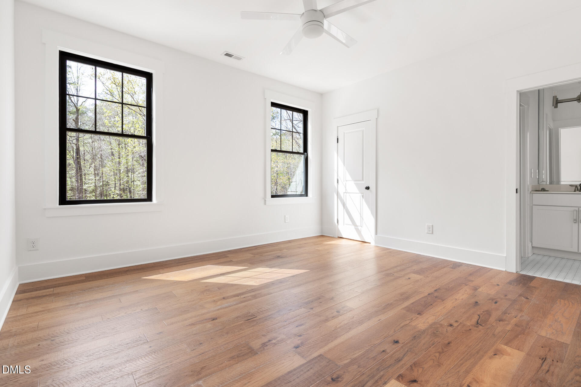 1117 Barley Stone Way Raleigh, NC 27603 - Photo 34 of 59 an empty room with wooden floor and windows