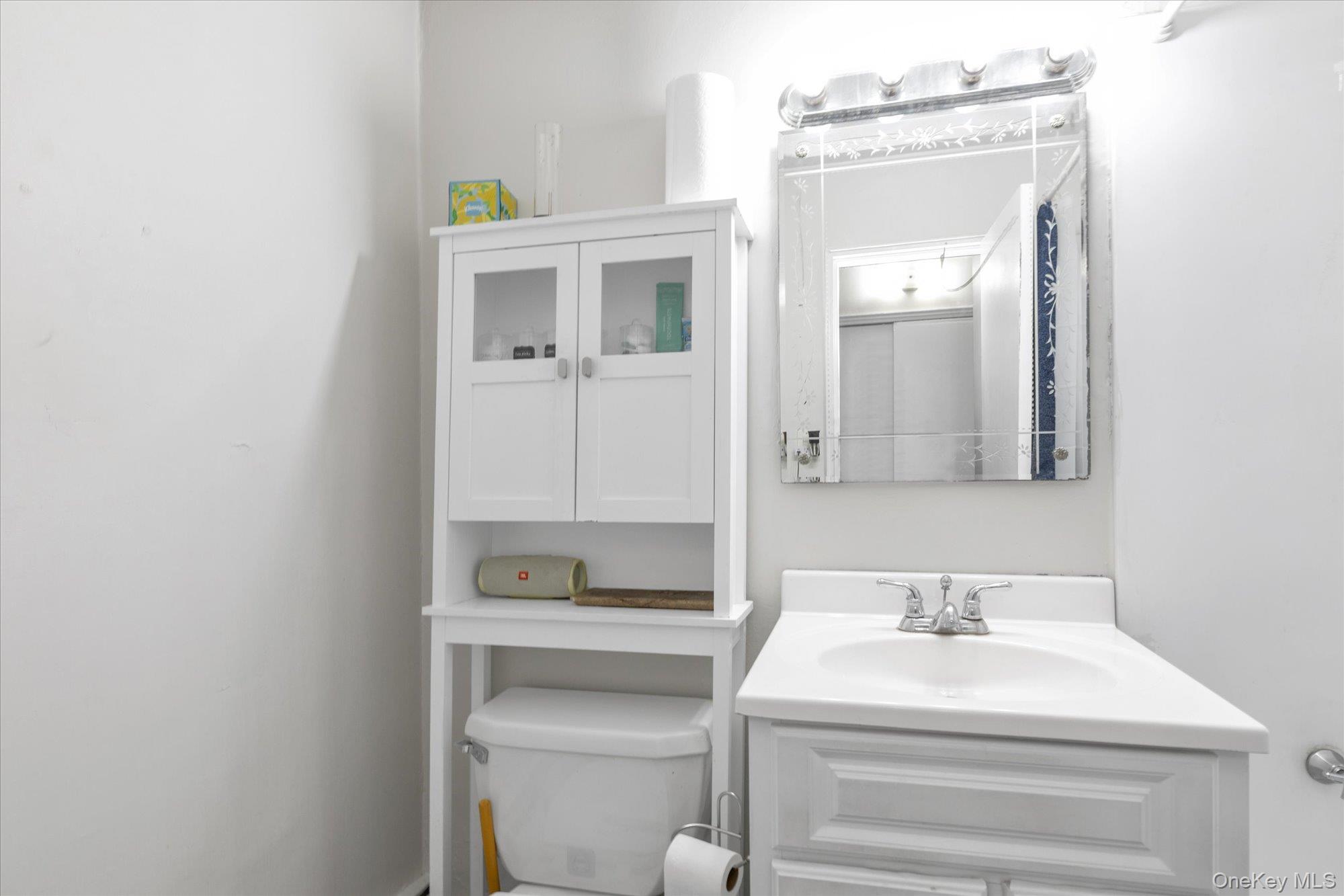 222 Smith Street, Unit 4F Freeport, NY 11520 - Photo 13 of 16 a bathroom with a sink vanity and mirror