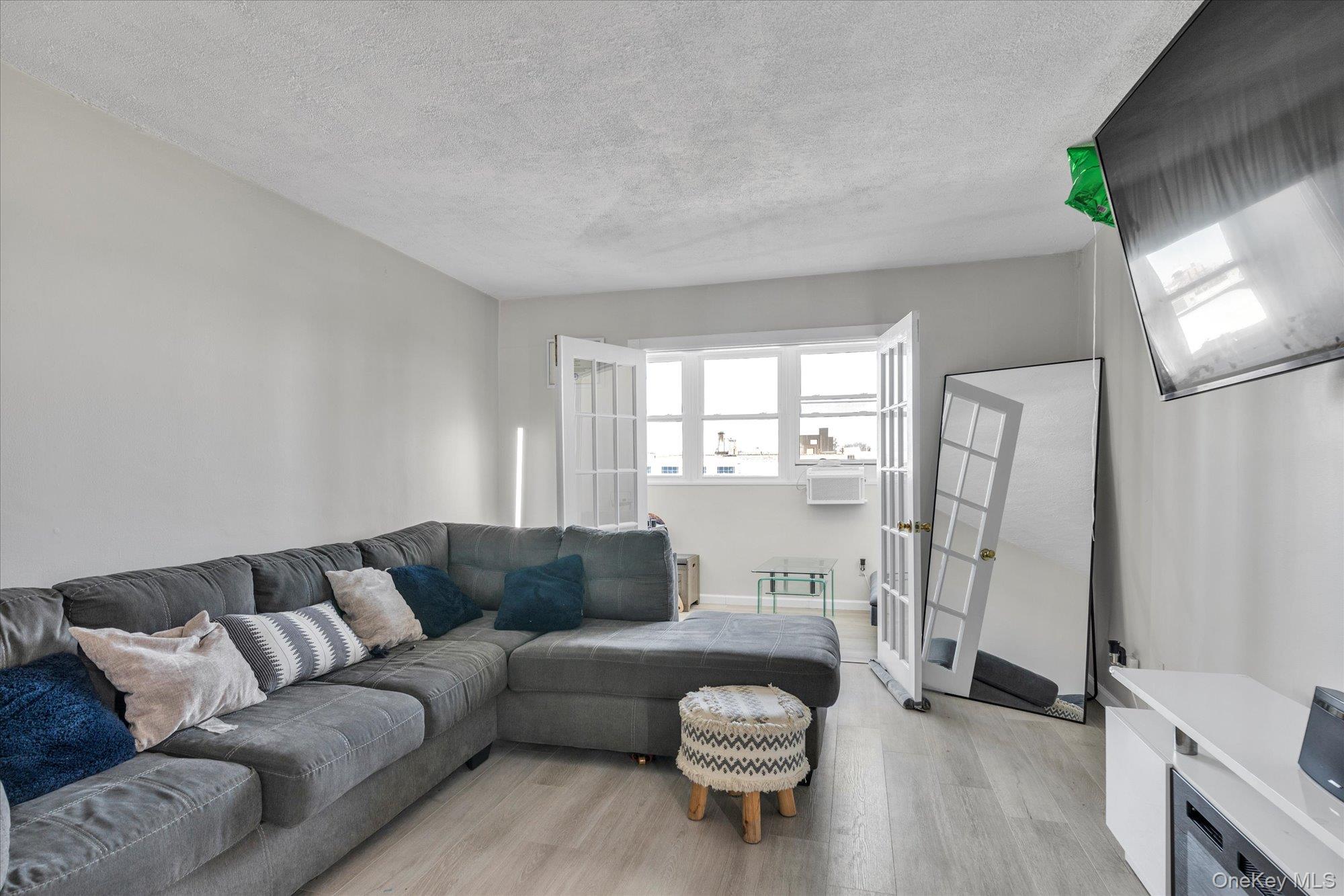 222 Smith Street, Unit 4F Freeport, NY 11520 - Photo 3 of 16 a living room with furniture and a window