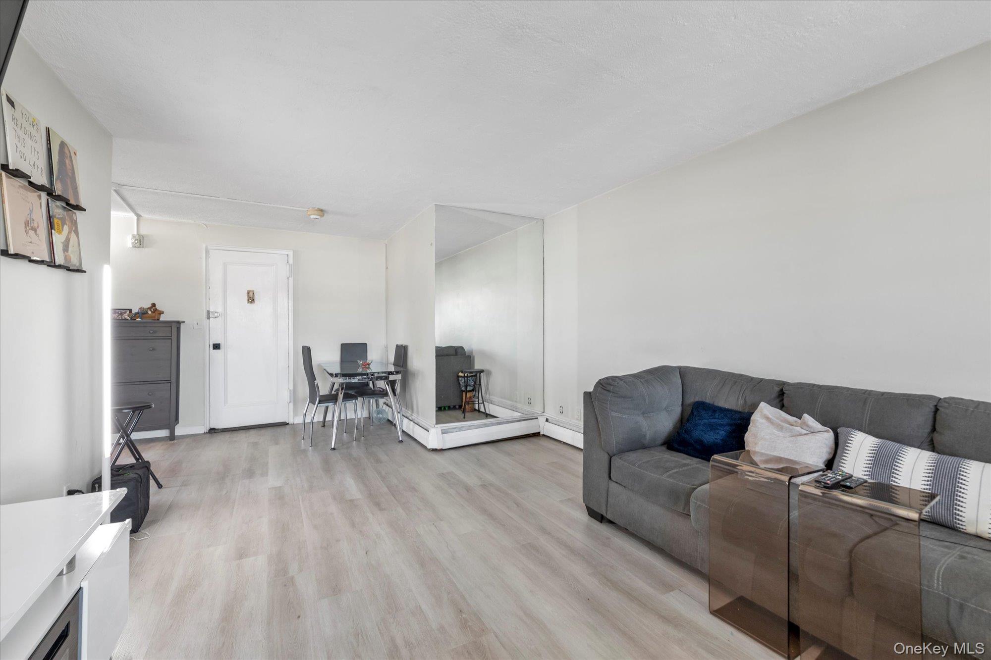 222 Smith Street, Unit 4F Freeport, NY 11520 - Photo 6 of 16 a living room with furniture and a table