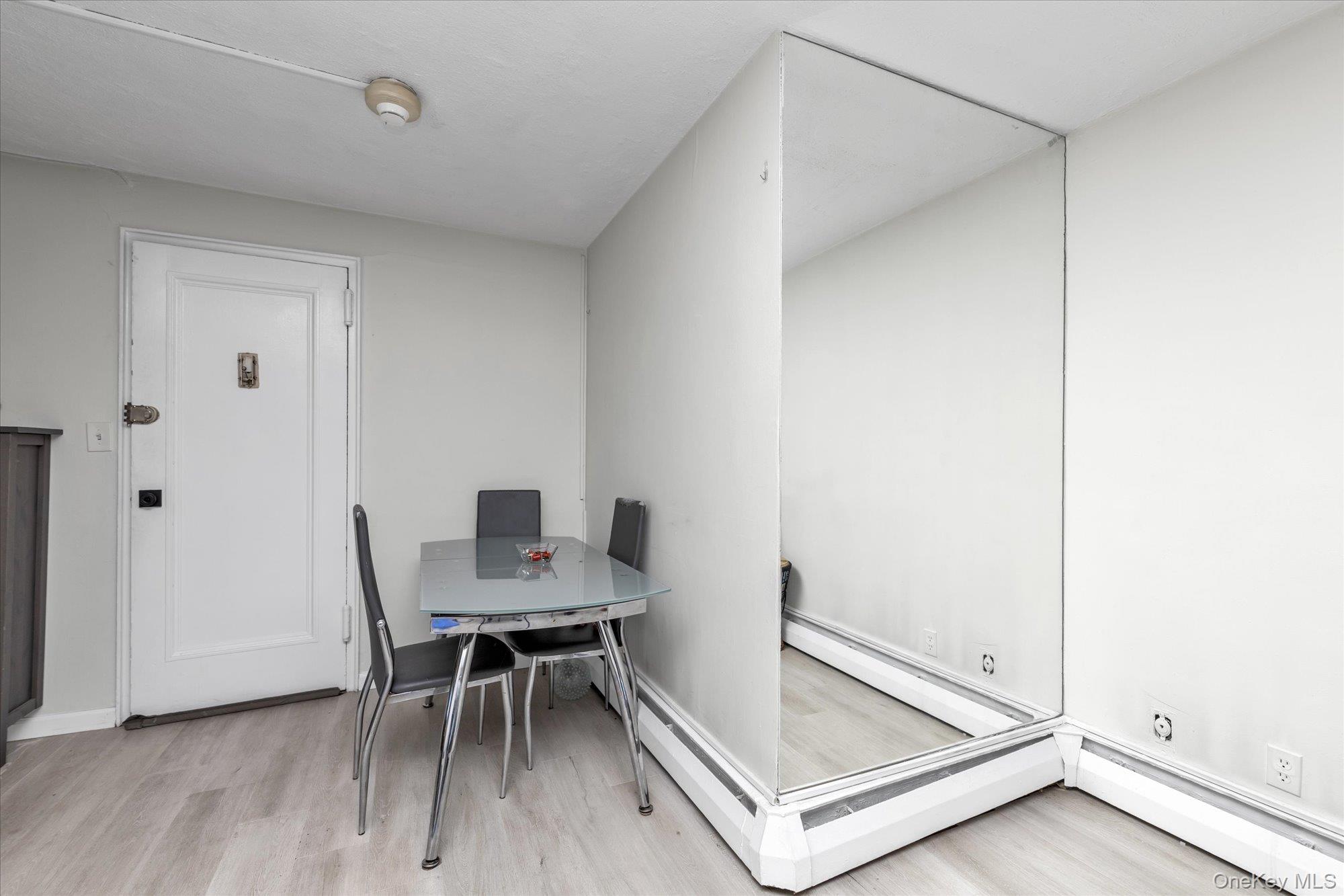 222 Smith Street, Unit 4F Freeport, NY 11520 - Photo 7 of 16 a workspace with furniture and wooden floor