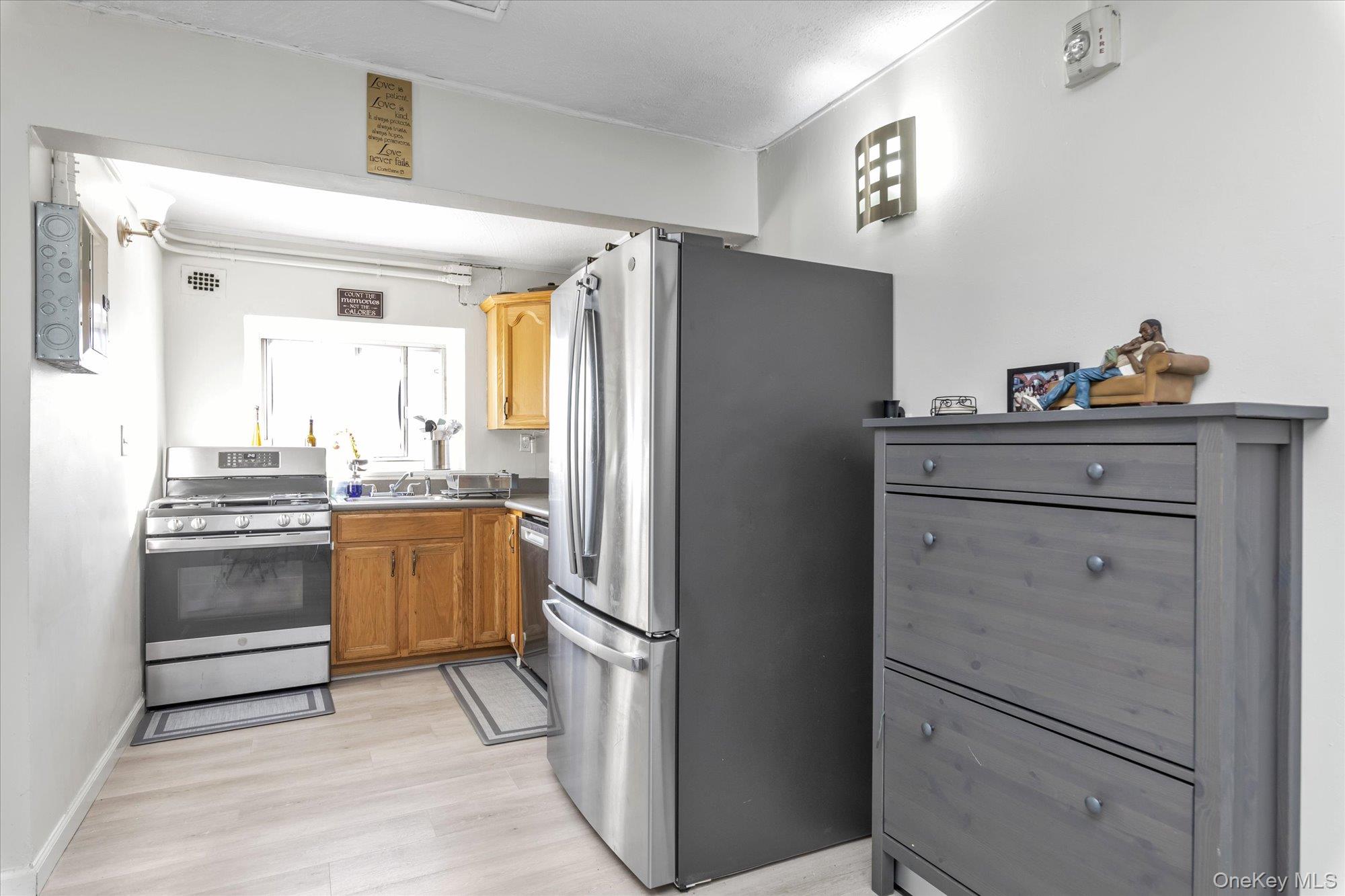 222 Smith Street, Unit 4F Freeport, NY 11520 - Photo 9 of 16 a kitchen with a refrigerator and countertop