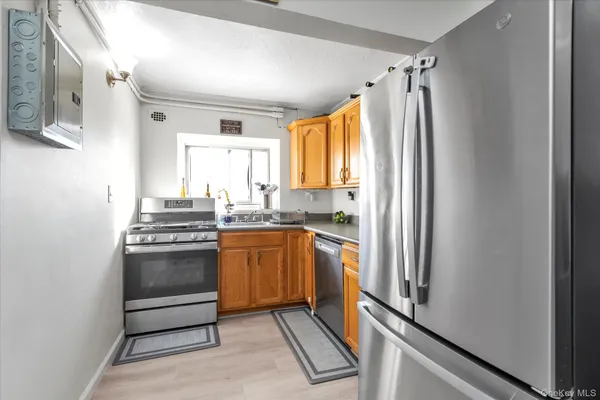 a kitchen with stainless steel appliances granite countertop a refrigerator and a sink