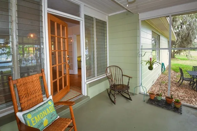 a bedroom with a bed a dresser and wooden floor