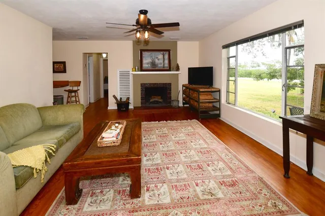 a bed sitting in a bedroom next to a window with wooden floor