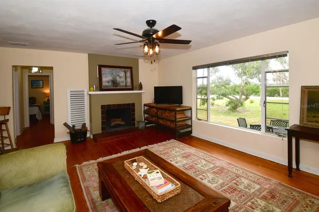 a view of a hallway with wooden floor and entryway