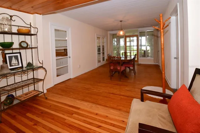 a dining room with furniture and wooden floor