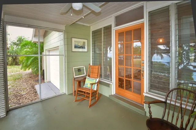 a bedroom with a bed and a flat tv screen on dresser