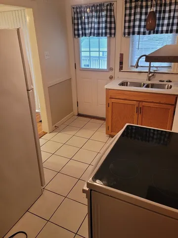 a kitchen with a sink and a refrigerator