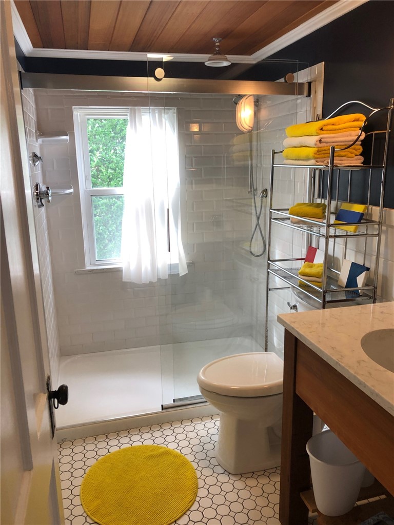 35 Rosa Road Middletown, RI 02842 - Photo 5 of 10 Renovated bathroom with large glass shower.
