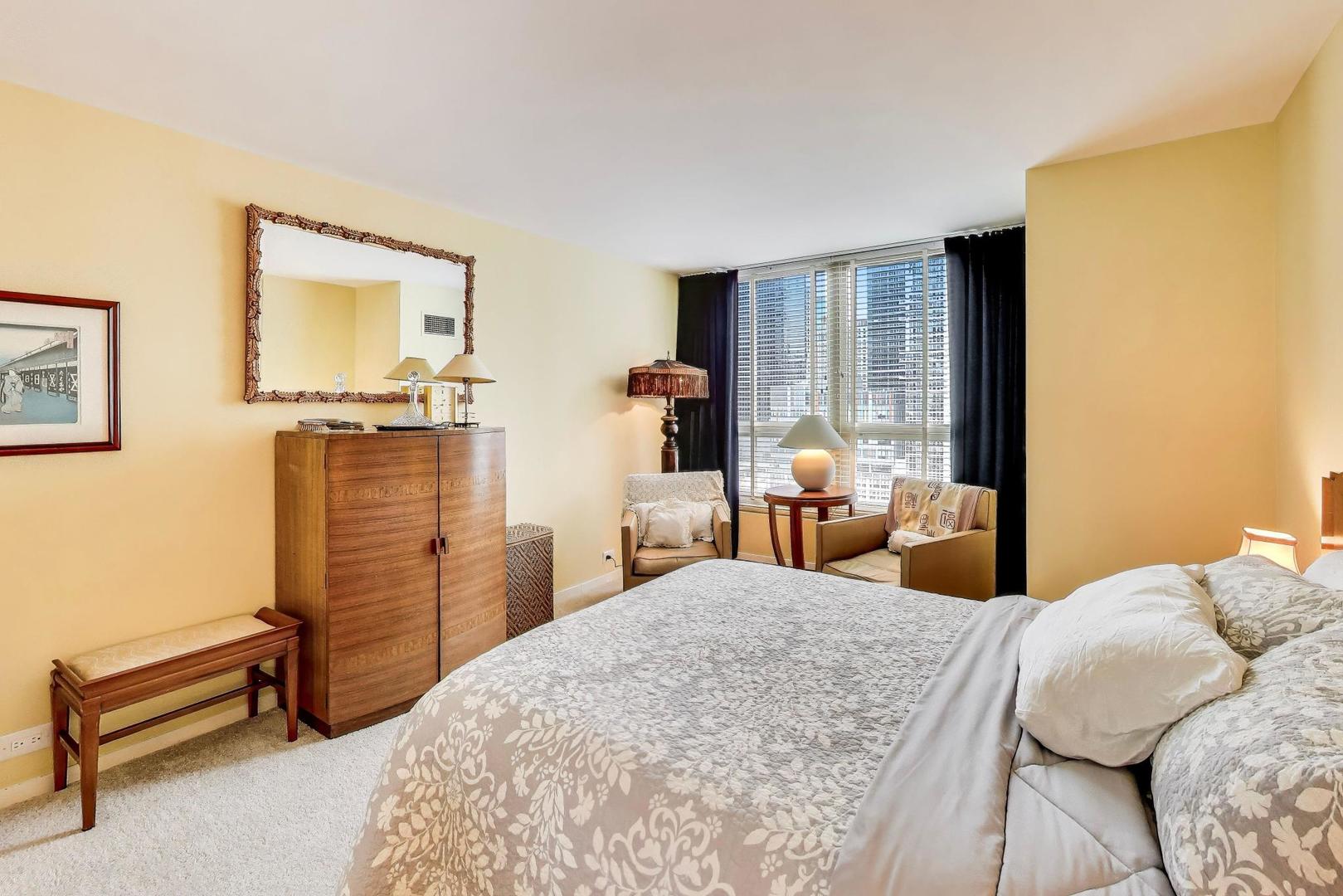 360 East Randolph Street, Unit 1007 Chicago, IL 60601 - Photo 12 of 28 a bedroom with a bed and wooden floor