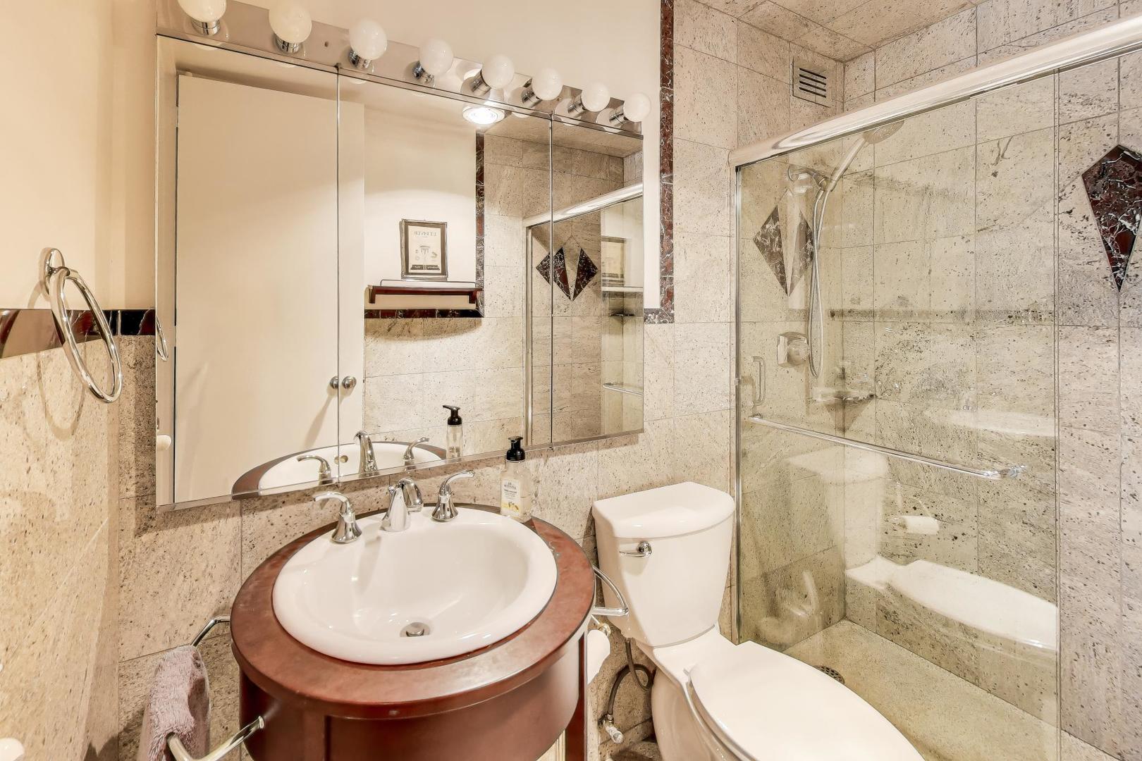360 East Randolph Street, Unit 1007 Chicago, IL 60601 - Photo 17 of 28 a bathroom with a sink toilet and shower