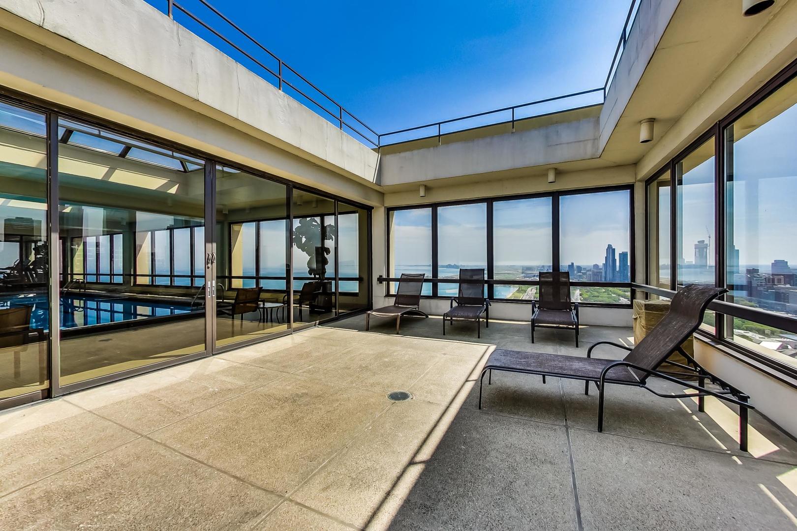 360 East Randolph Street, Unit 1007 Chicago, IL 60601 - Photo 22 of 28 a swimming pool with chairs