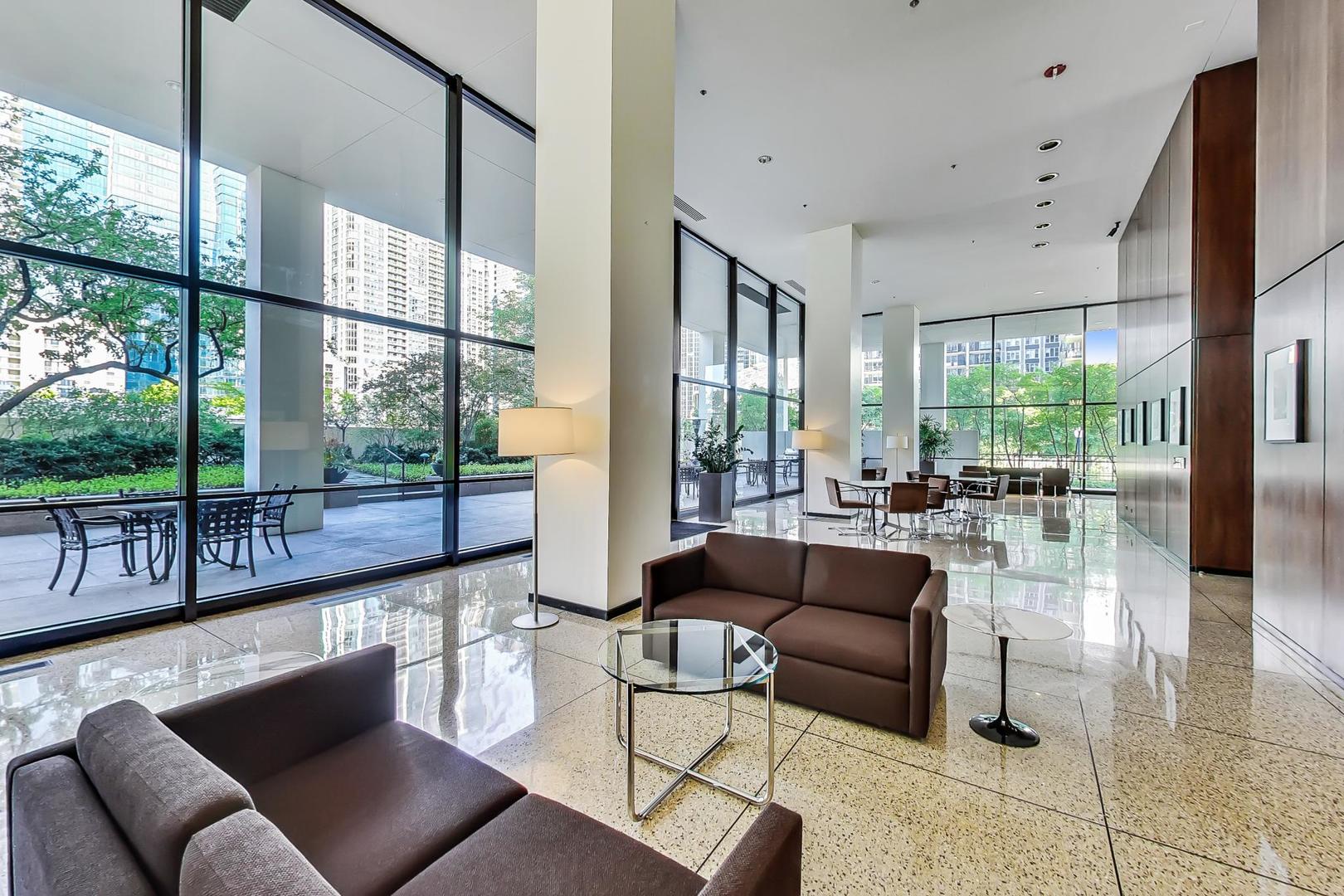 360 East Randolph Street, Unit 1007 Chicago, IL 60601 - Photo 5 of 28 a living room with furniture and a large window