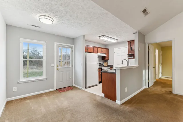 a view interior of kitchen and refrigerator
