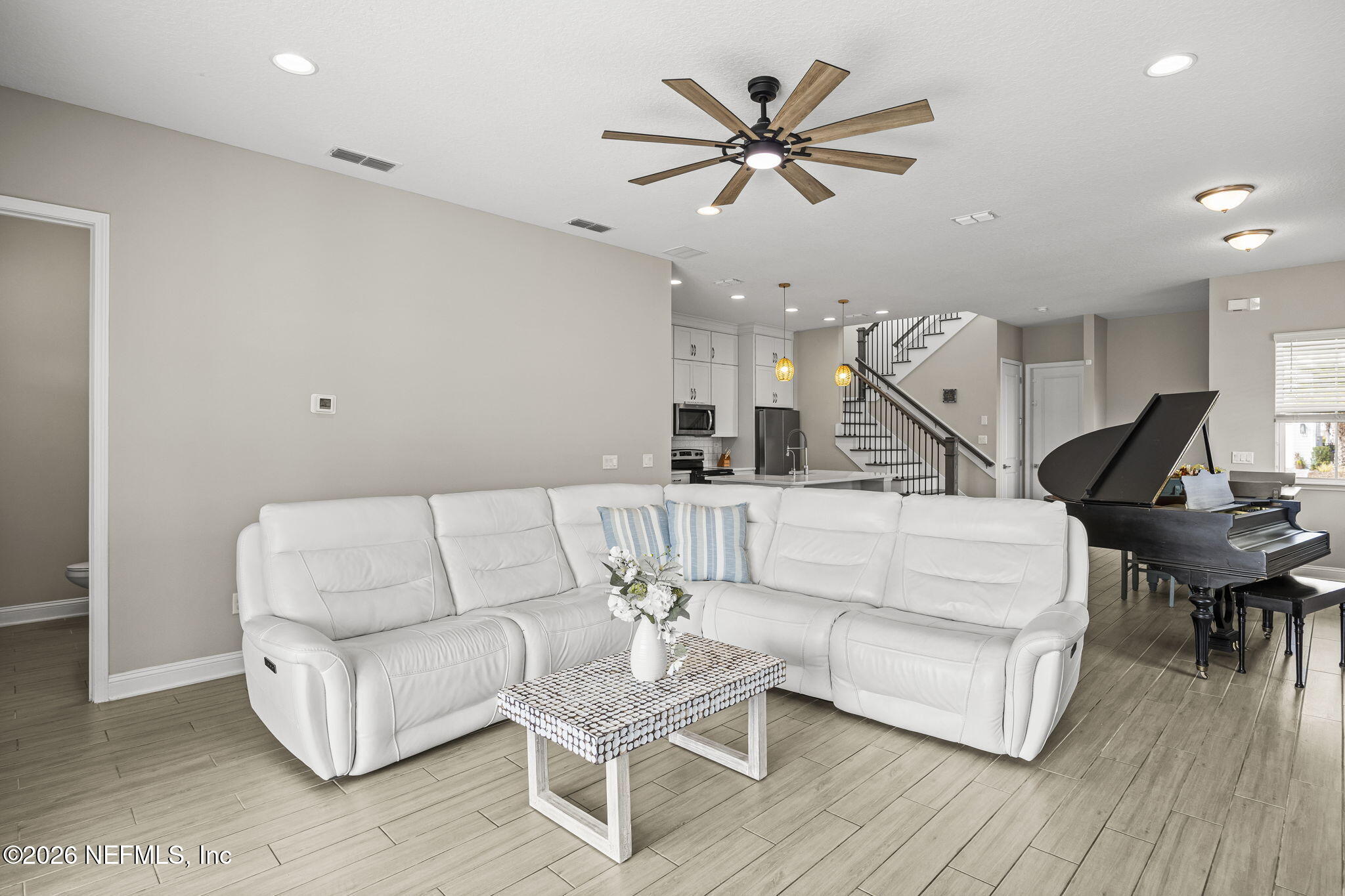 385 Rum Runner Way St. Johns, FL 32259 - Photo 10 of 35 a living room with couches and kitchen view with wooden floor