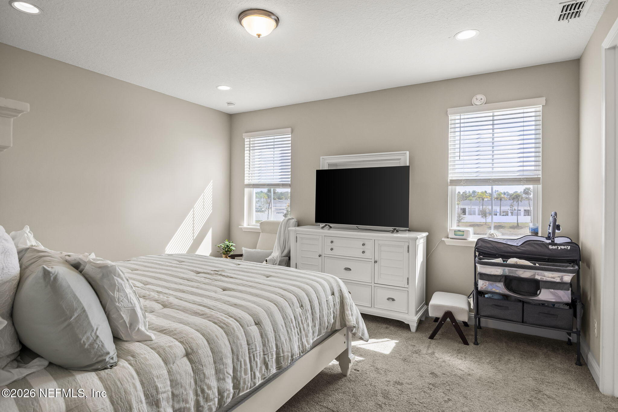385 Rum Runner Way St. Johns, FL 32259 - Photo 16 of 35 a bedroom with a bed and a flat screen tv