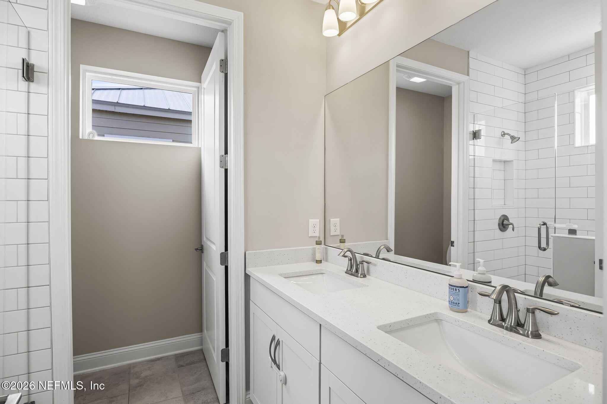 385 Rum Runner Way St. Johns, FL 32259 - Photo 17 of 35 a bathroom with a sink and a mirror