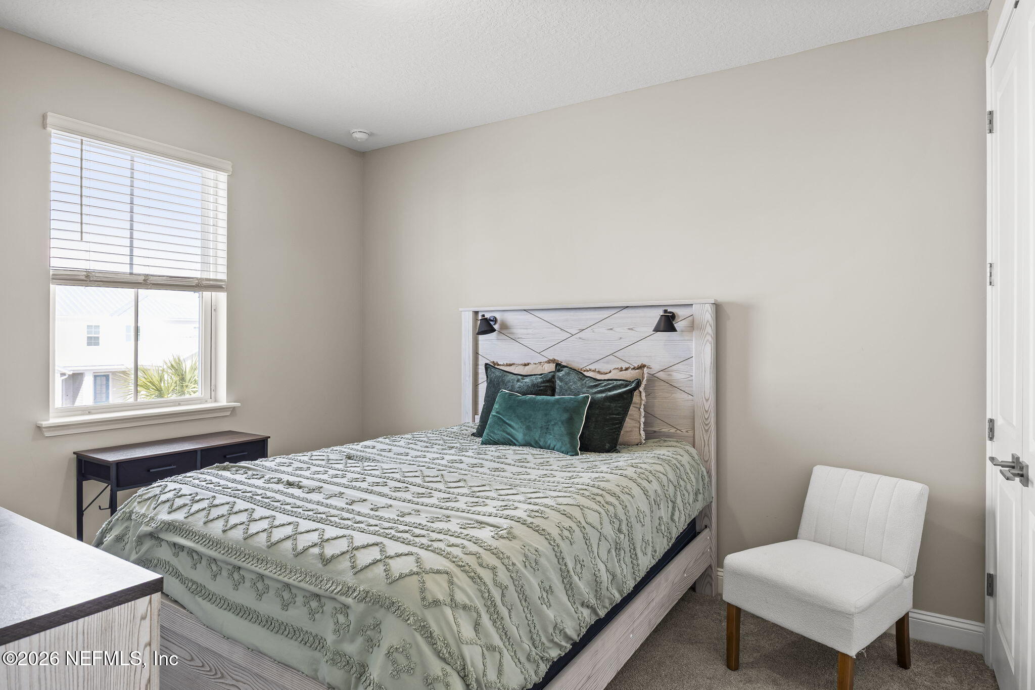 385 Rum Runner Way St. Johns, FL 32259 - Photo 20 of 35 a bedroom with a bed a couch and a window