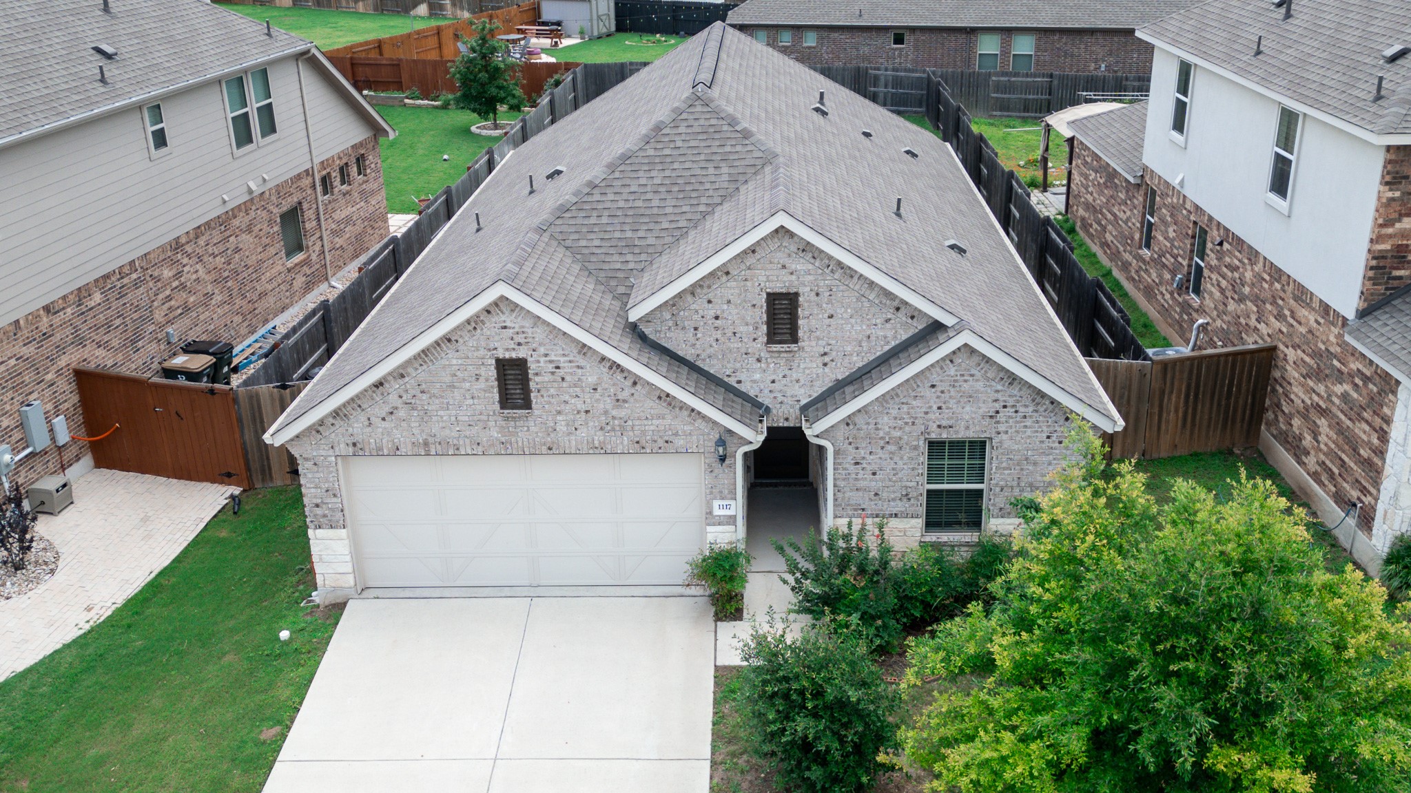 1117 Terrace View Georgetown, TX 78628 - Photo 1 of 25 Gable roofline residence featuring a gray brick and stone facade