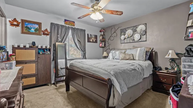 a bedroom with a bed and a refrigerator