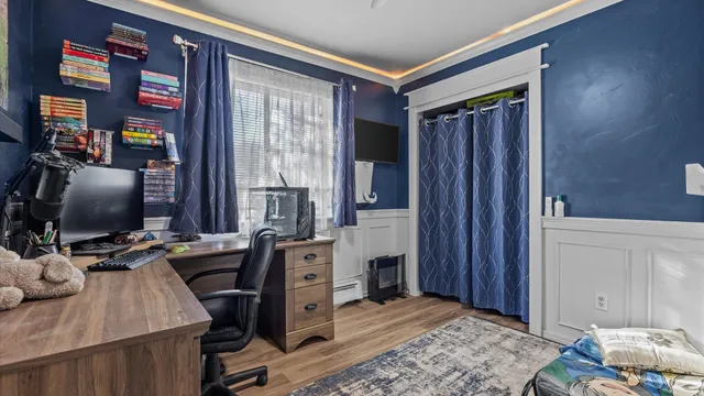 a view of a workspace with furniture and a window