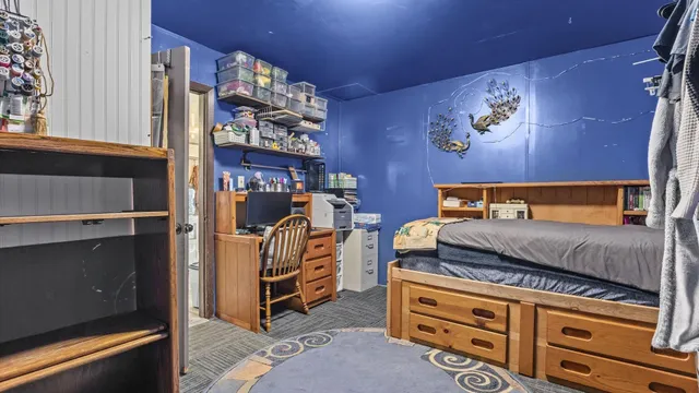 a bedroom with bed and cabinets