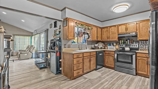 a kitchen with stainless steel appliances granite countertop a stove and cabinets