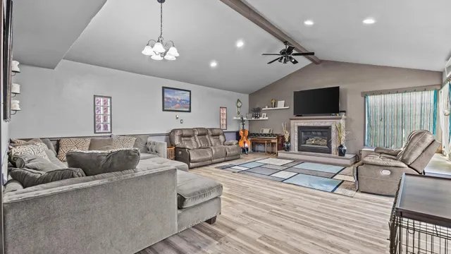 a living room with furniture a fireplace and a flat screen tv